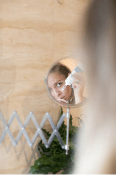 woman applying moisturizer