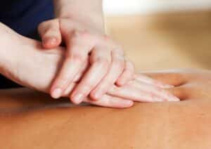 hands massaging a back