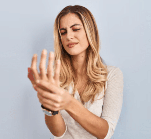 woman holding her sore hand