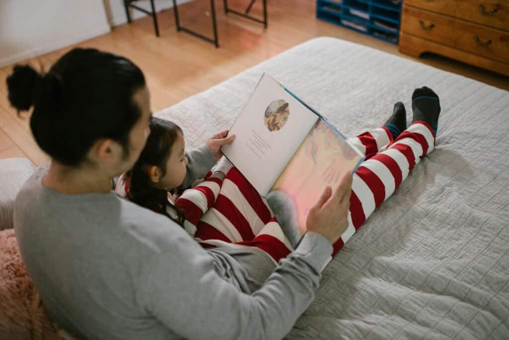 father and child reading together