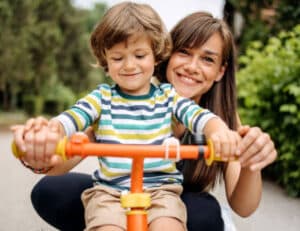 Mom and son on a tricycle together