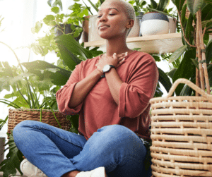 woman meditating with hands on heart