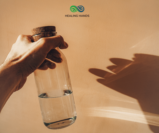 a person holding a glass of water